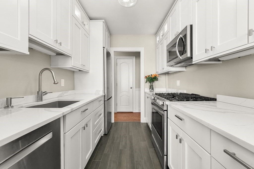 a kitchen with stainless steel appliances granite countertop a stove and a sink