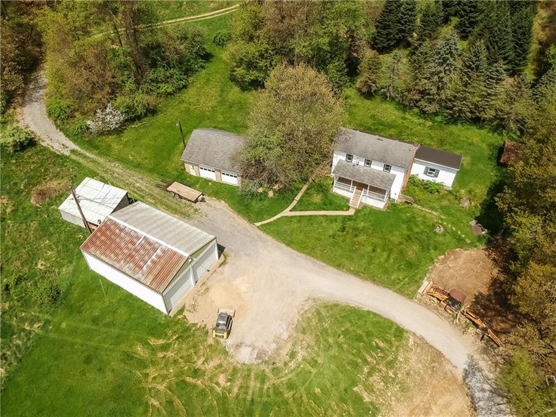 an aerial view of a house with a yard and lake view