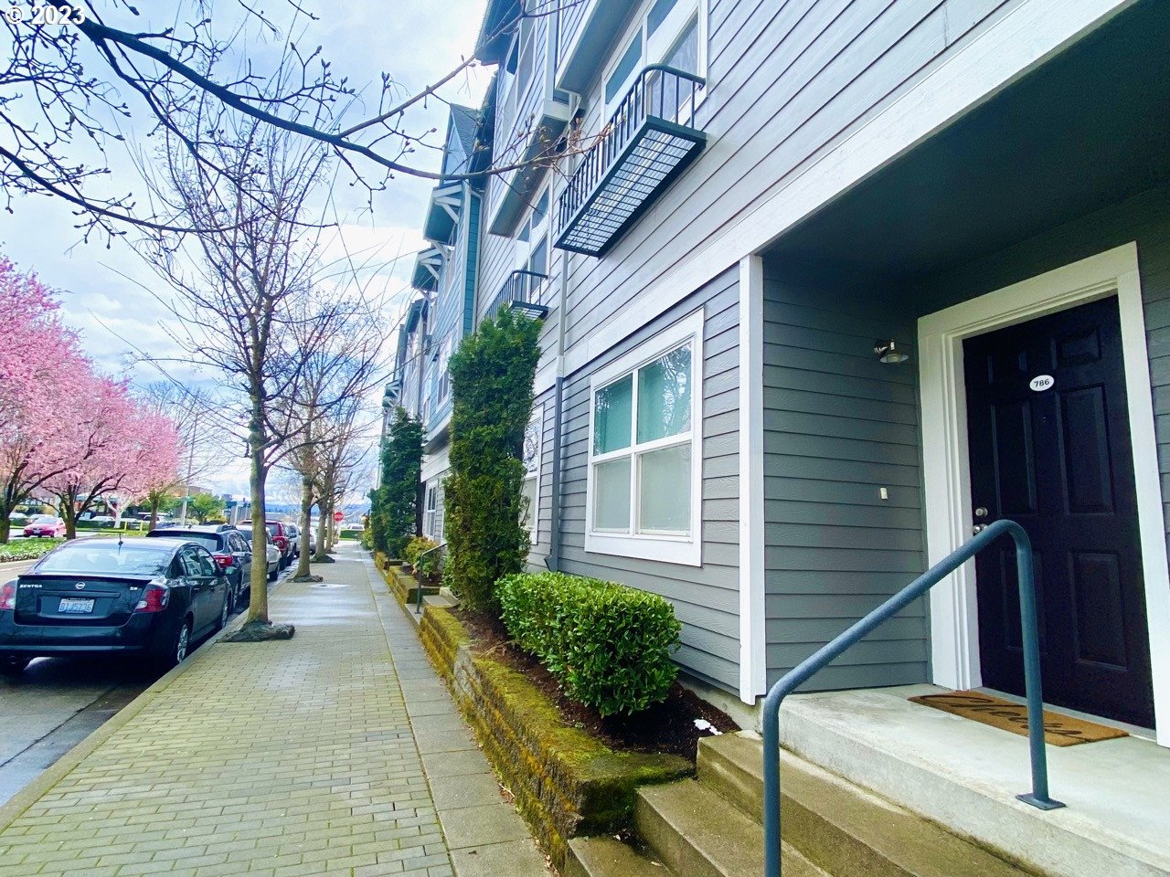 a couple of cars parked in front of a house