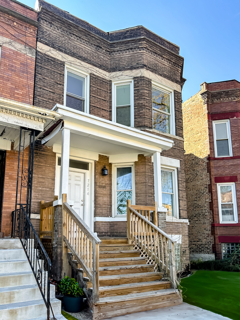 front view of a brick house with a large windows