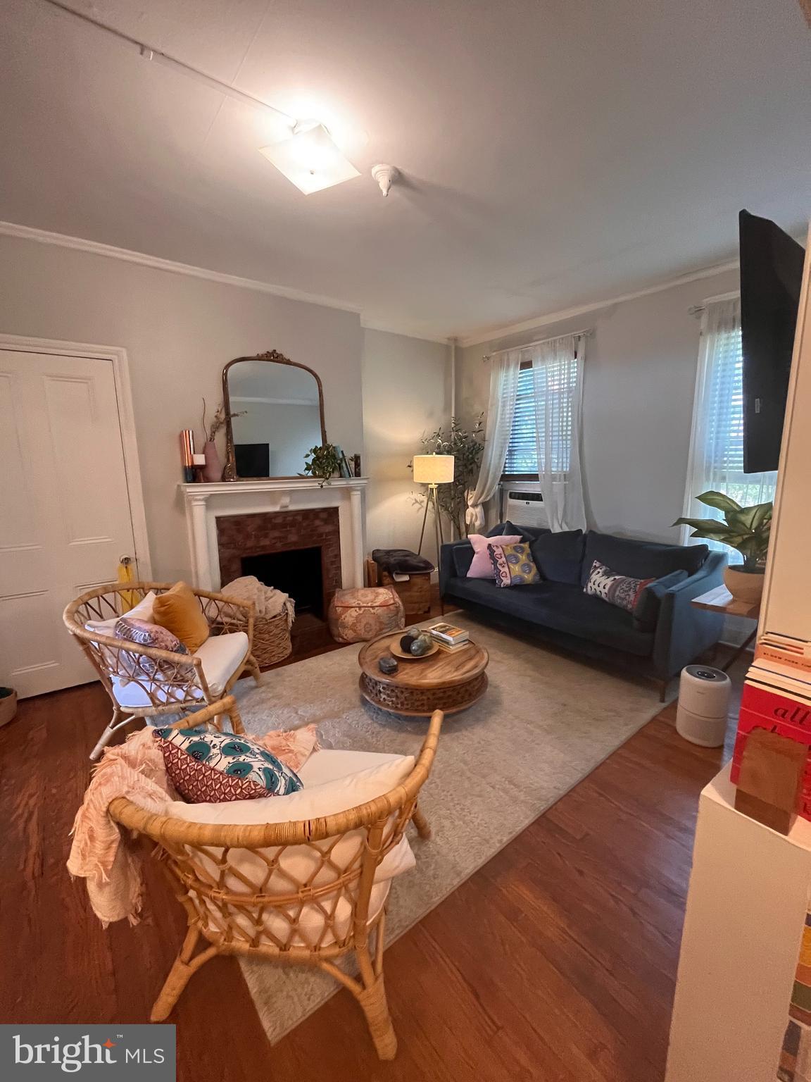 a living room with furniture a fireplace and a flat screen tv