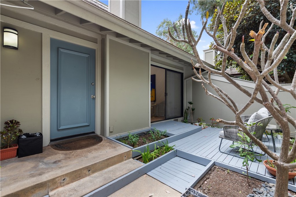 a backyard of a house with wooden floor and fence