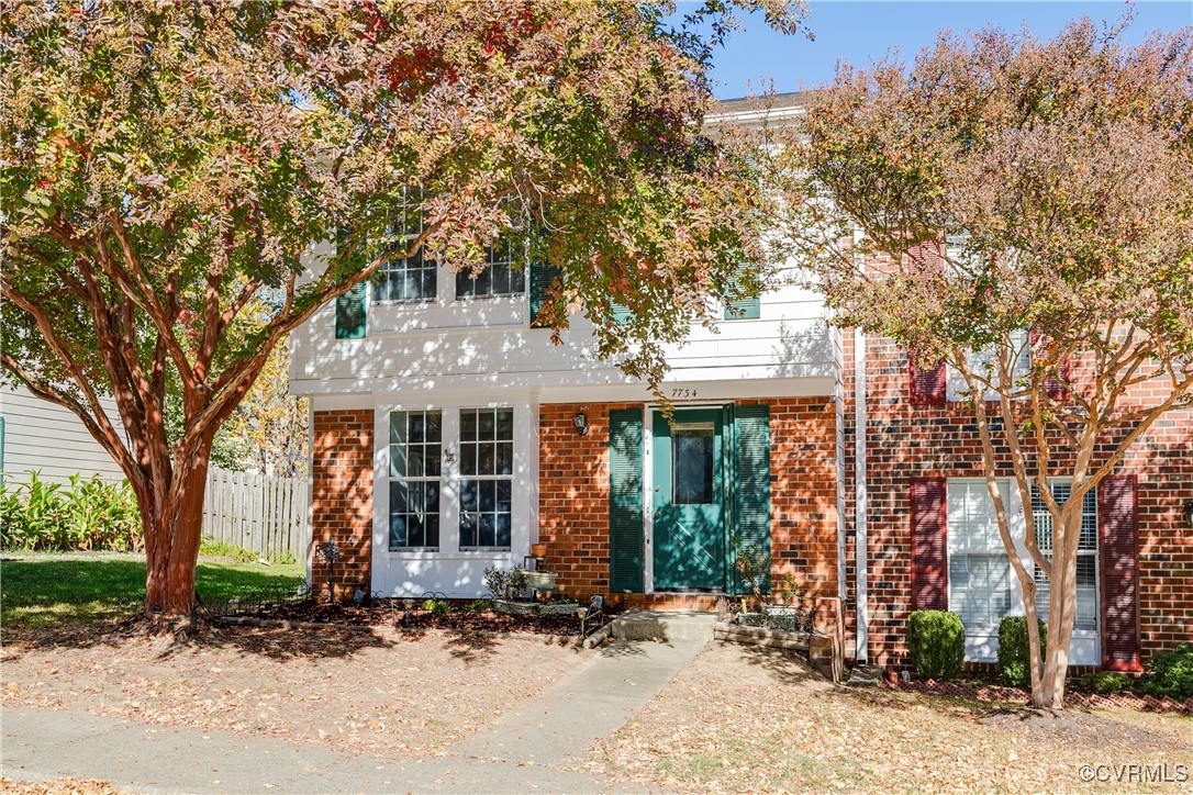 front view of a house with a tree in front