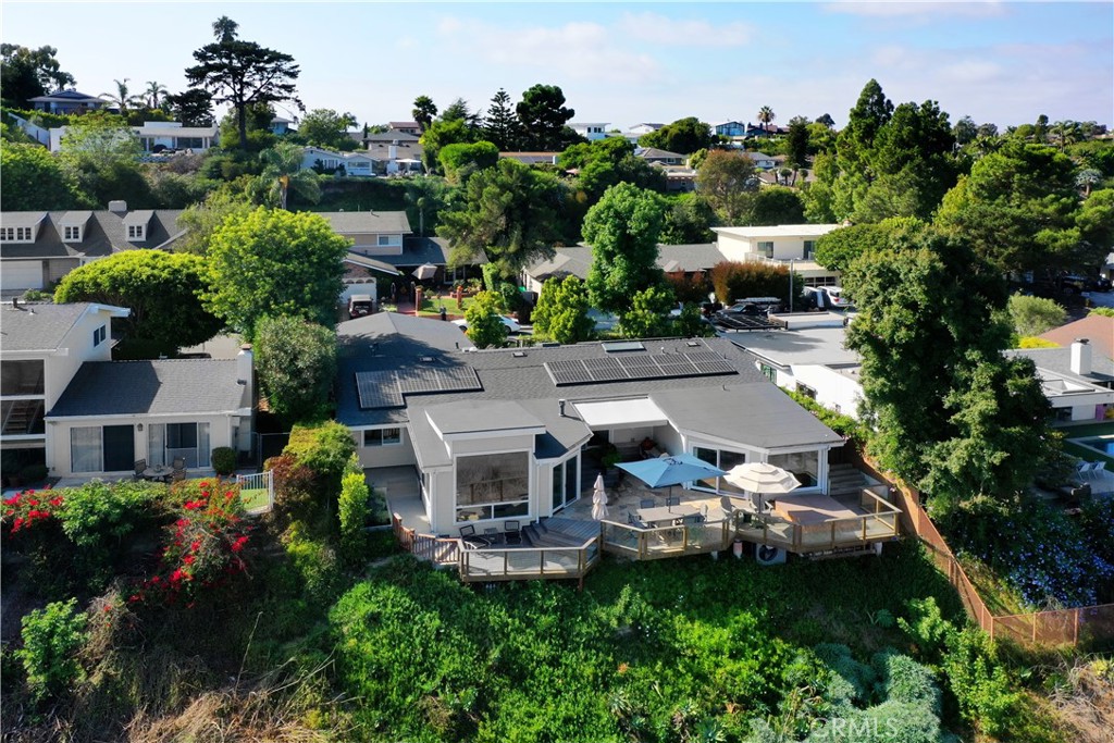 an aerial view of a house with swimming pool a yard and outdoor seating