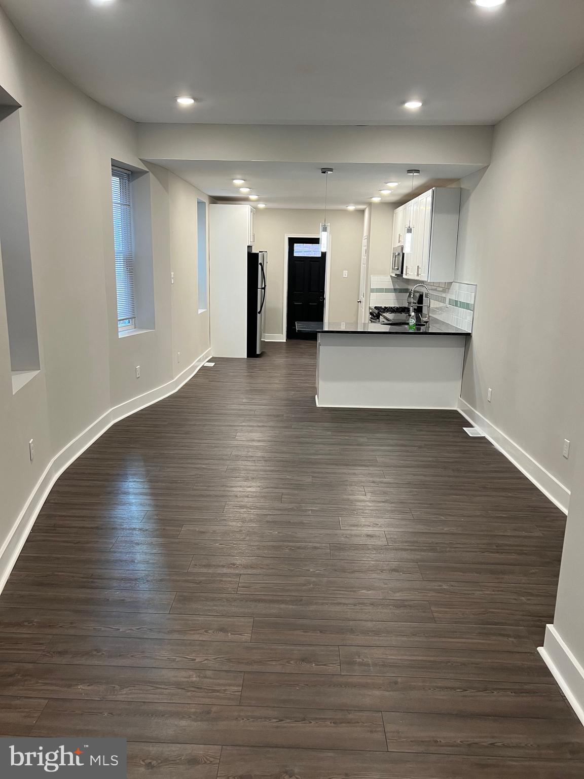 a view of kitchen with cabinets and wooden floor