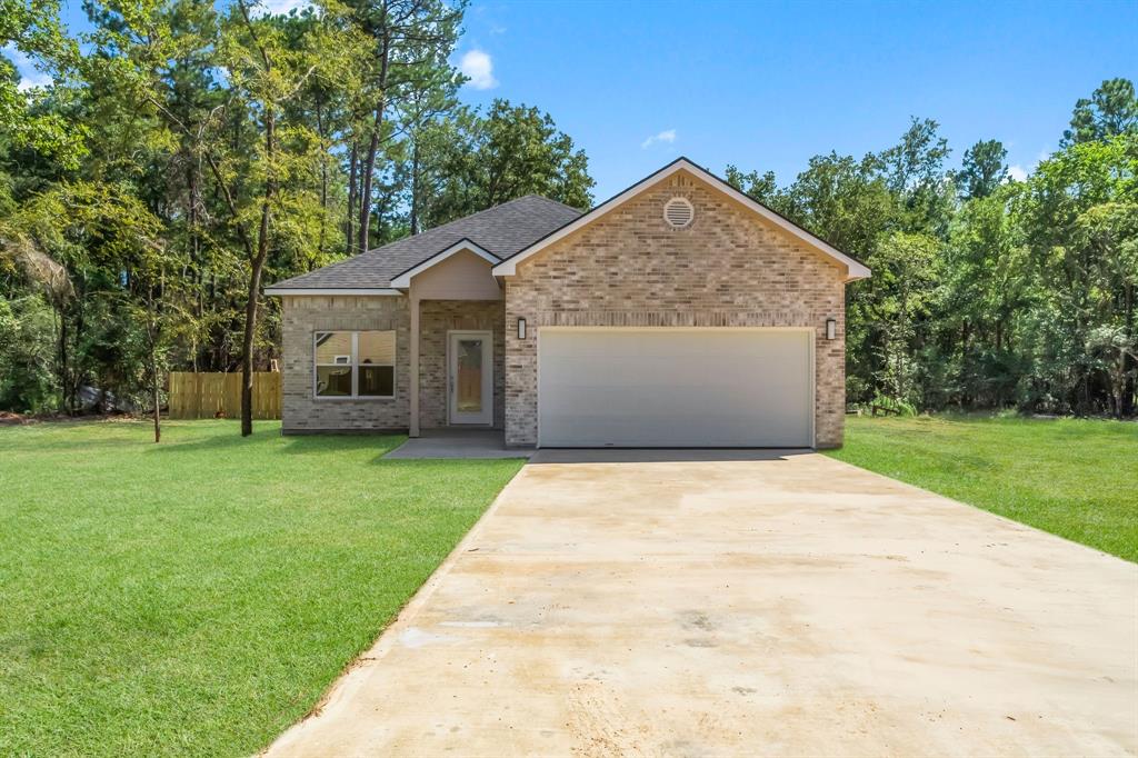 a view of house with outdoor space and garden