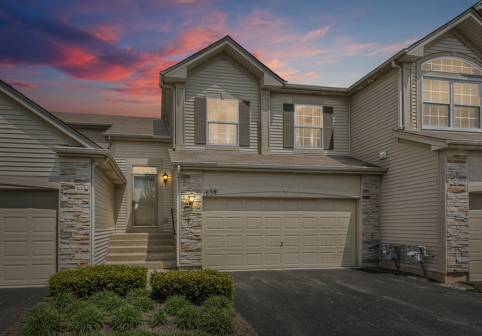 a front view of a house with a garage