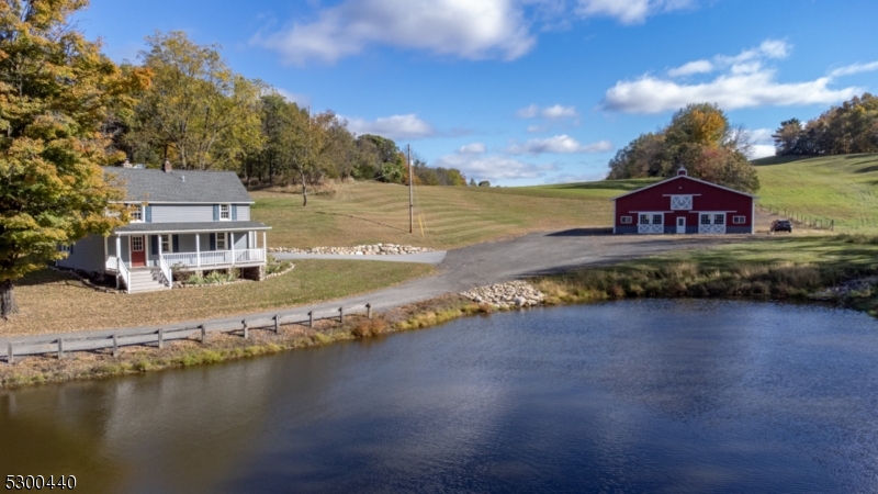 a front view of a house with a yard and lake view