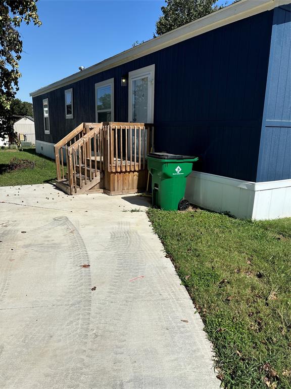 a view of a house with a yard and pathway