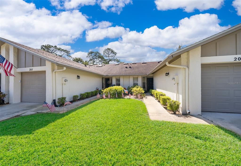 a front view of a house with a yard and garage