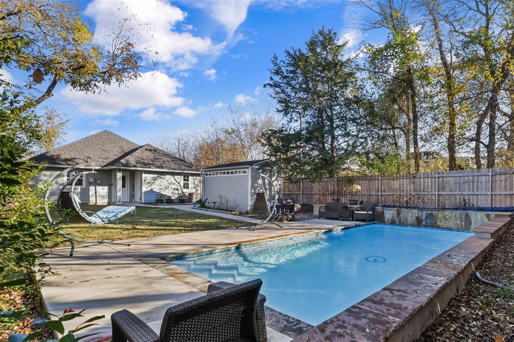 a view of a house with swimming pool and sitting area