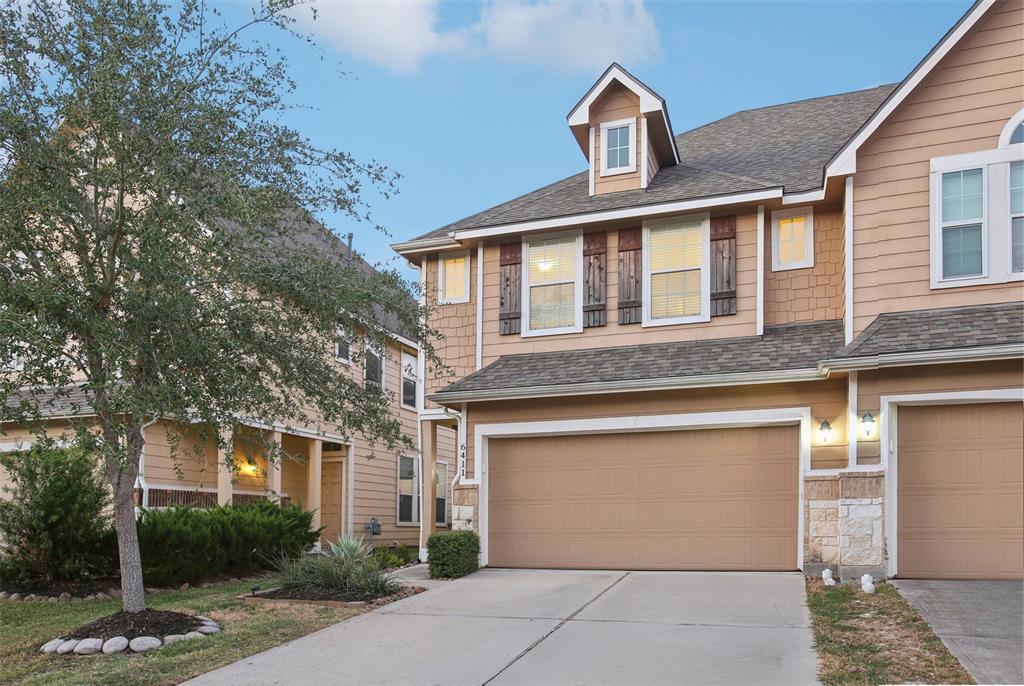 a front view of a house with a yard garage and glass door