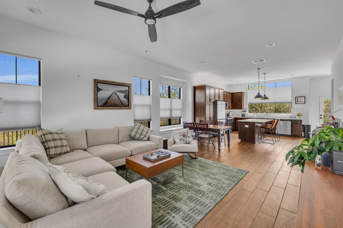 a living room with furniture and a wooden floor