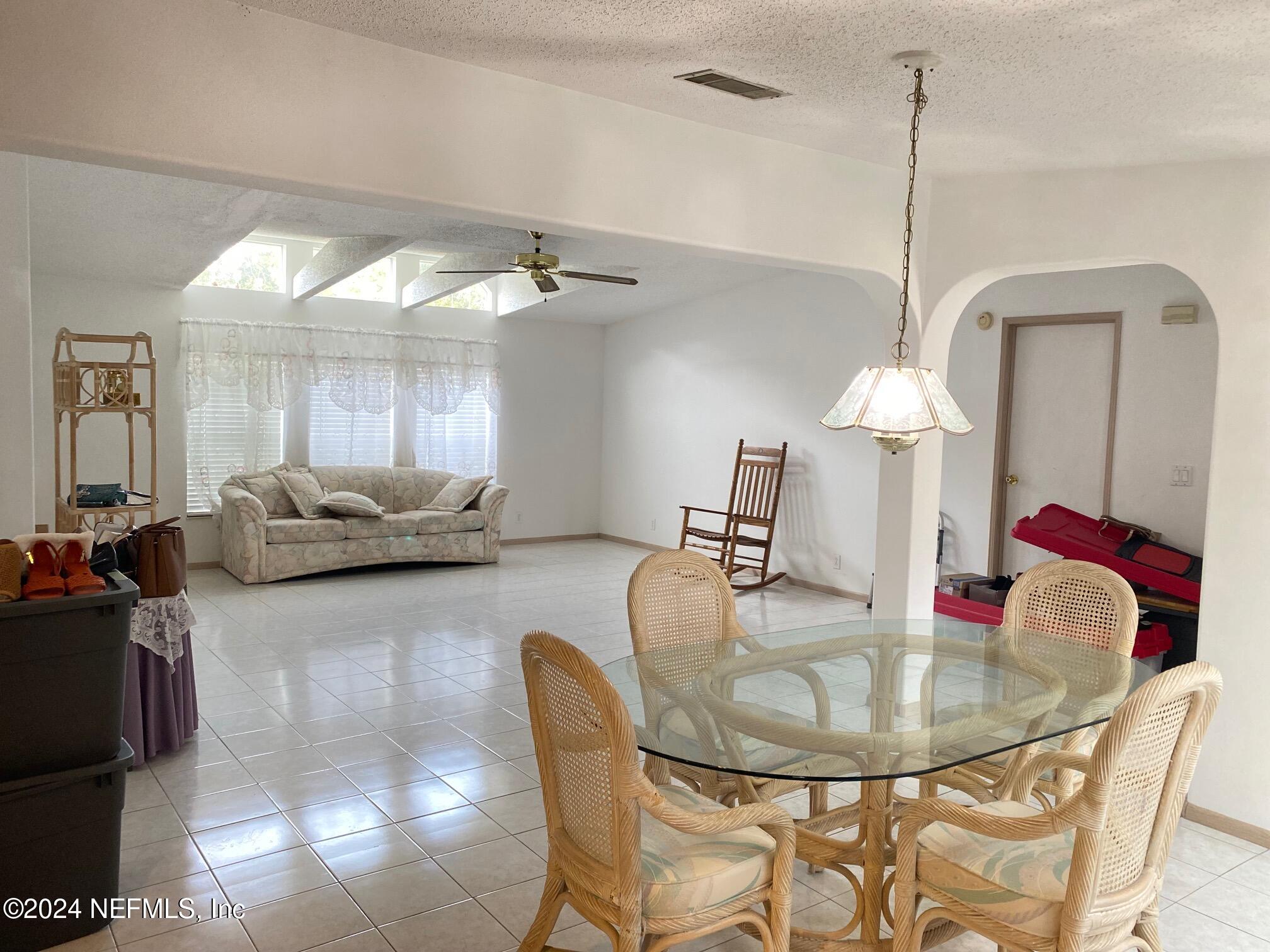 a dining room with furniture and a chandelier