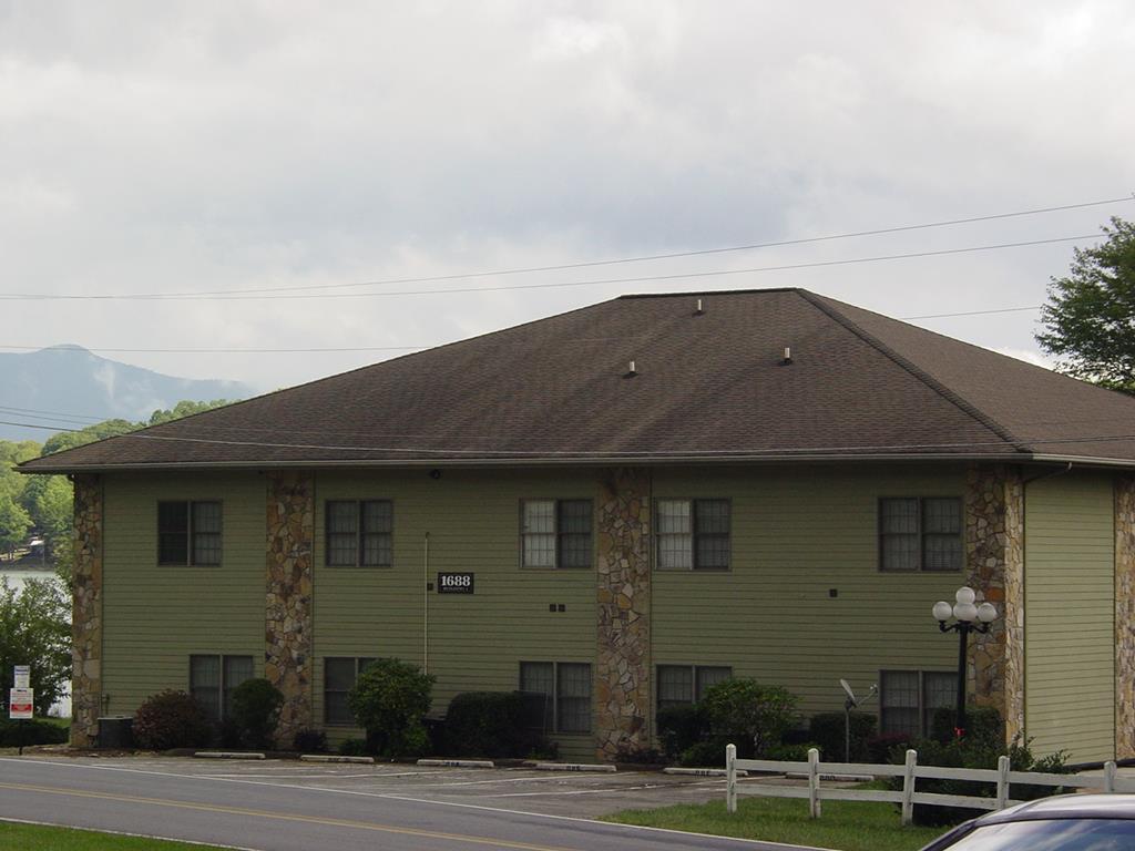 a brick house next to a yard