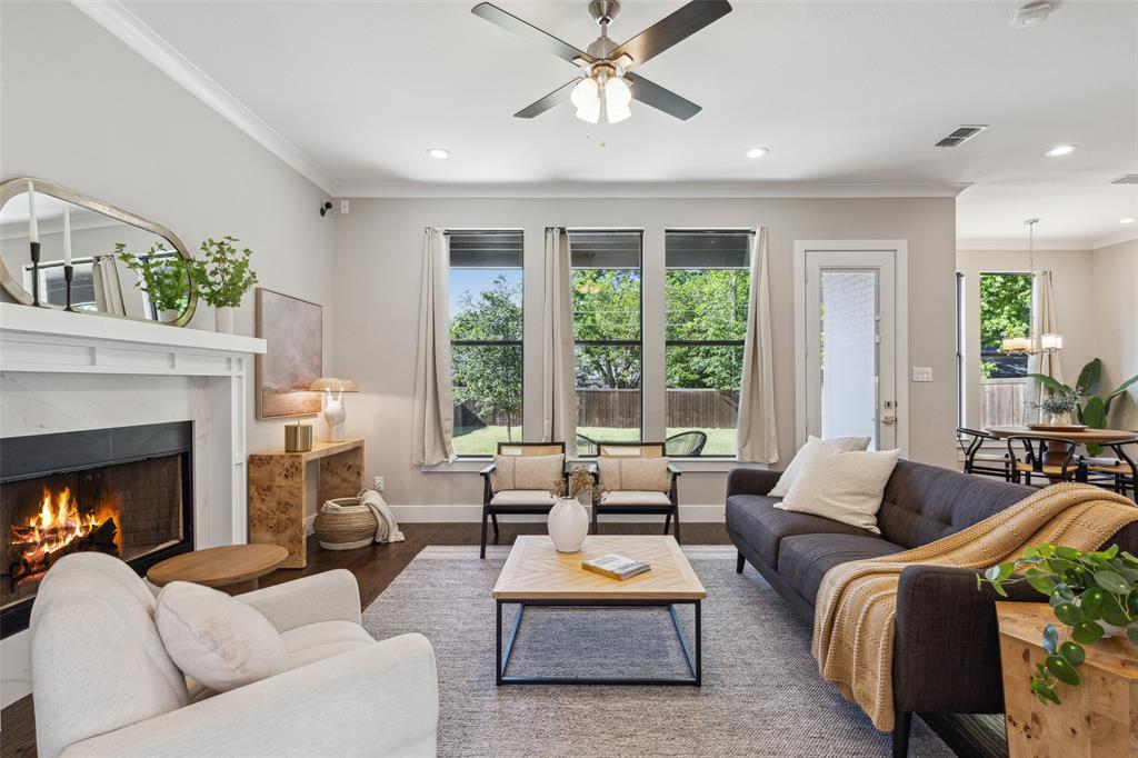 a living room with furniture fireplace and a large window