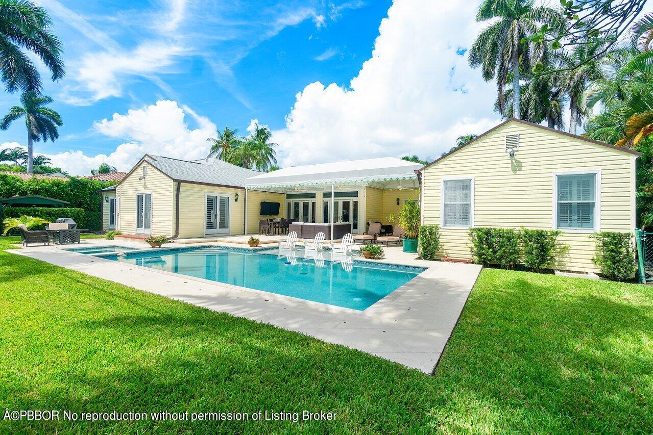 a view of house with swimming pool and porch