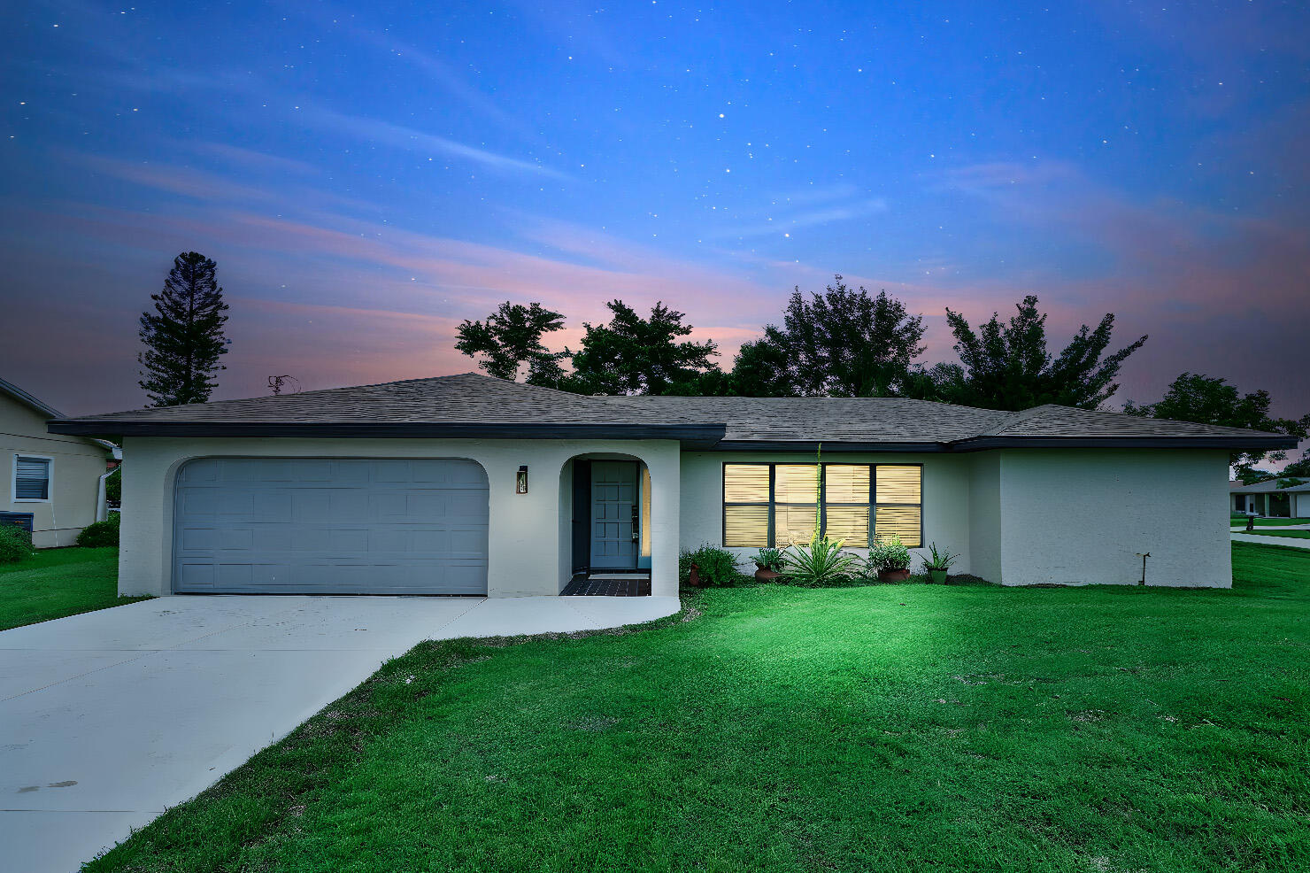 a front view of a house with a garden and yard