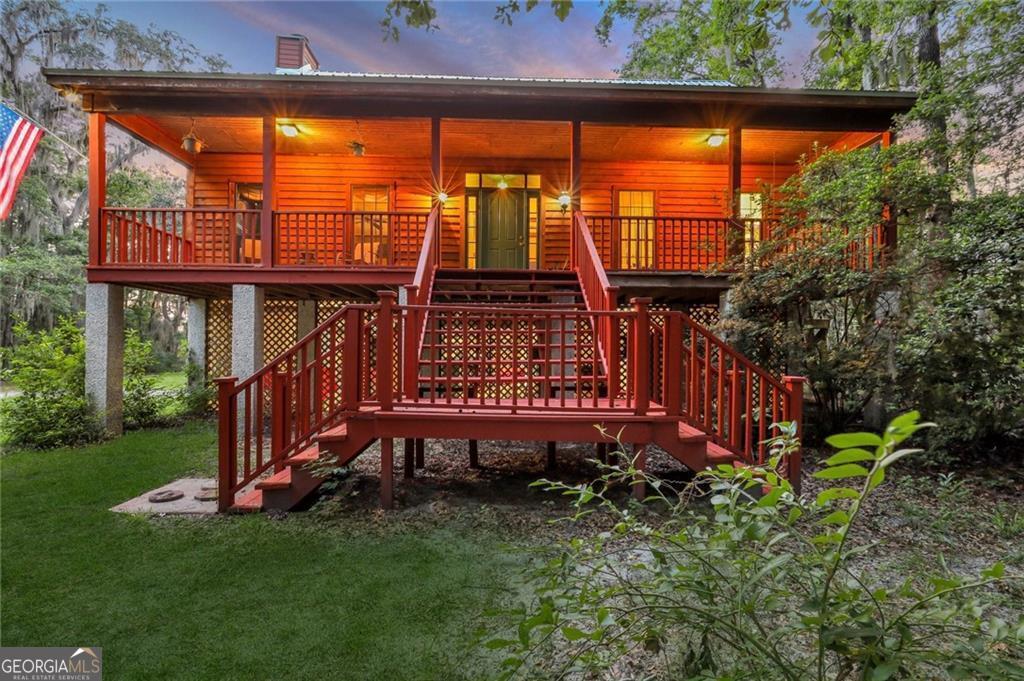 a view of a backyard with a deck and a garden