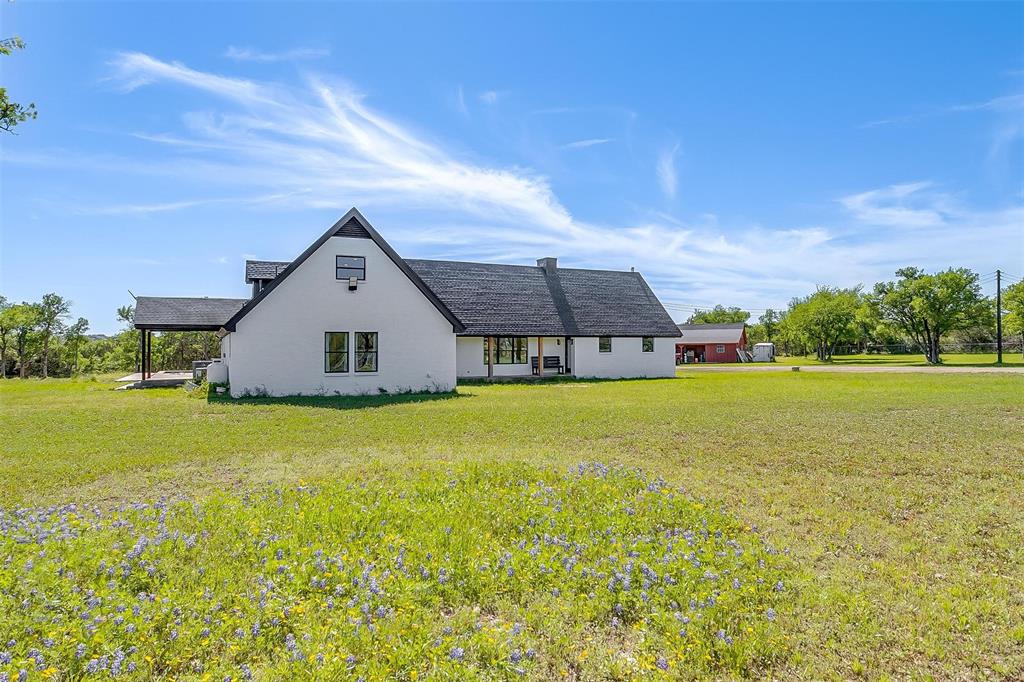 a front view of house with yard and green space