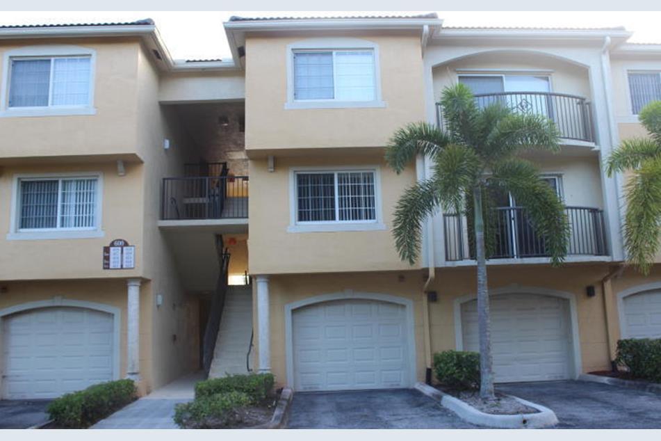 a front view of a house with garage