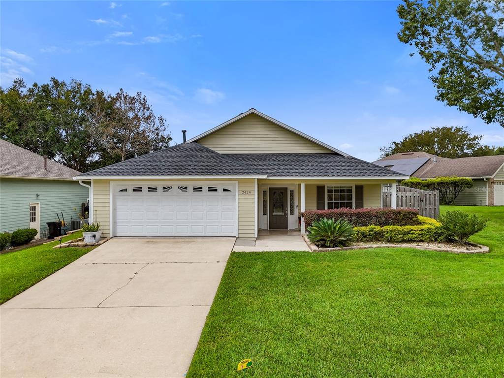 a front view of a house with a yard and garage