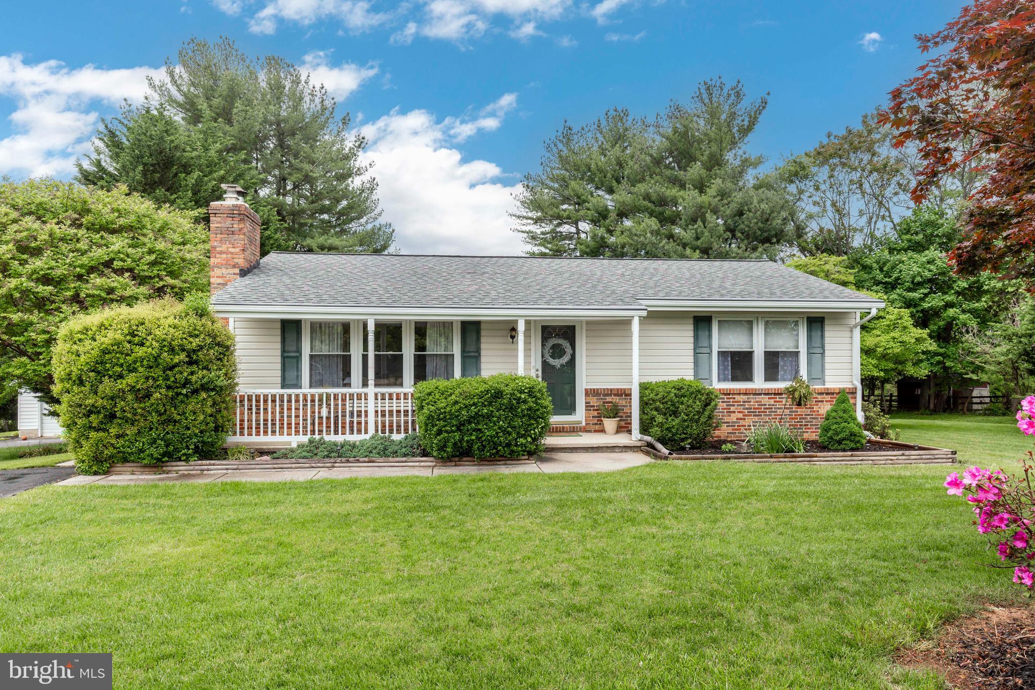 a front view of house with yard and green space