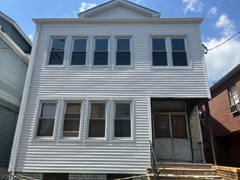 a view of a house with more windows and brick walls