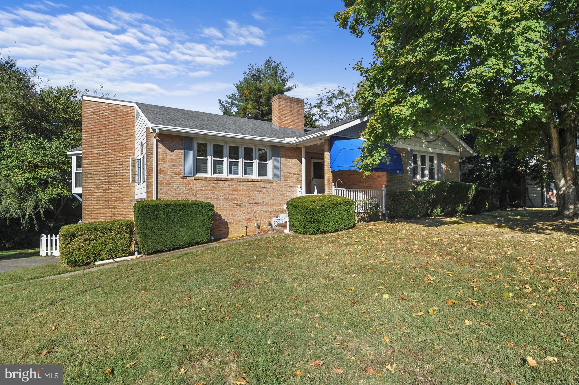 a front view of house with yard and trees around