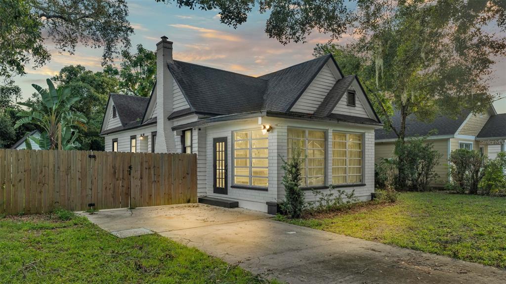 a front view of a house with a garden