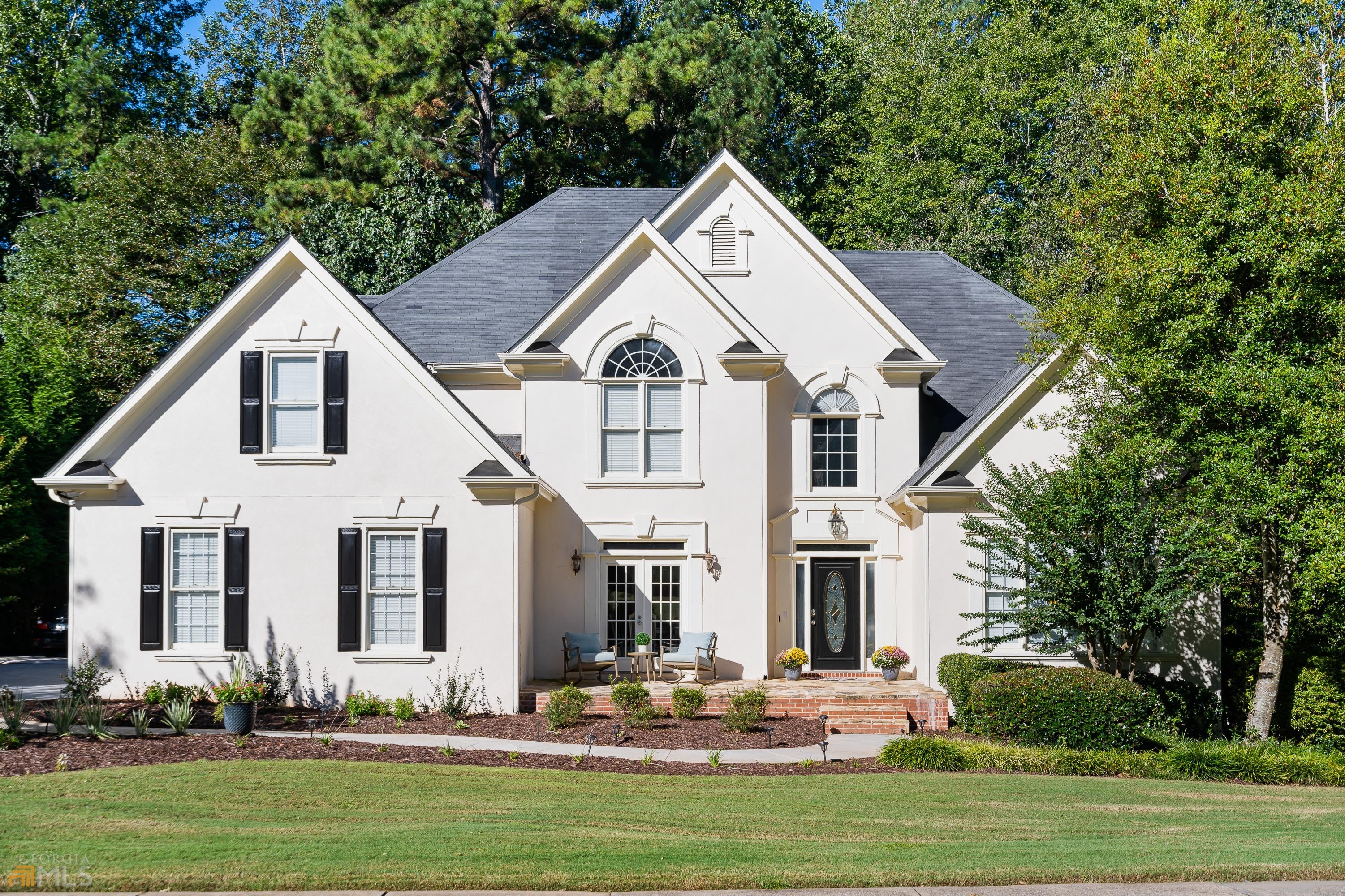 a front view of a house with a garden