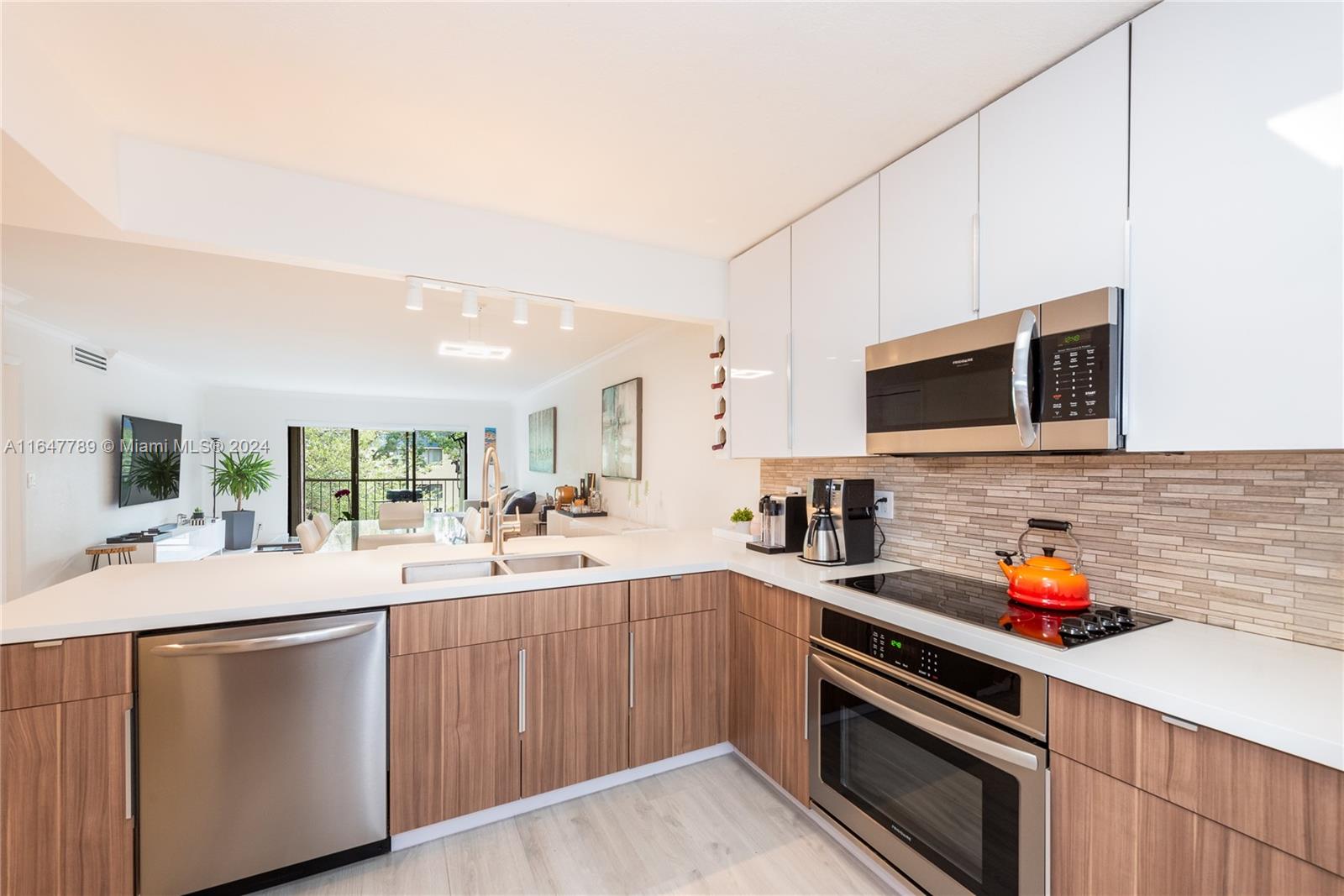 a kitchen with stainless steel appliances a sink dishwasher stove microwave and cabinets