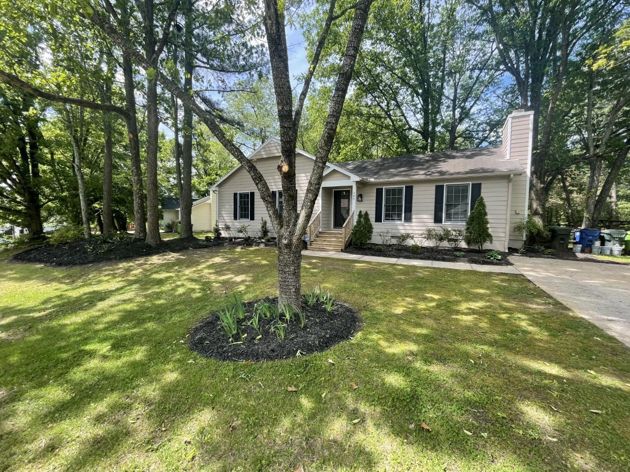 a front view of house with yard and trees