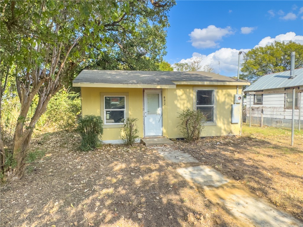 front view of a house with a yard