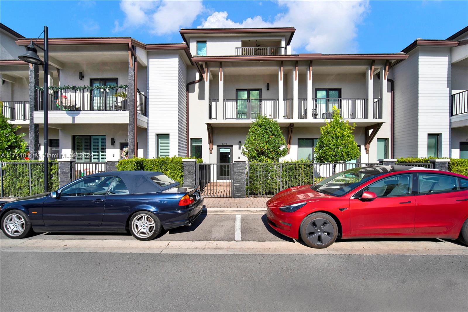 front view of a house with a cars parked