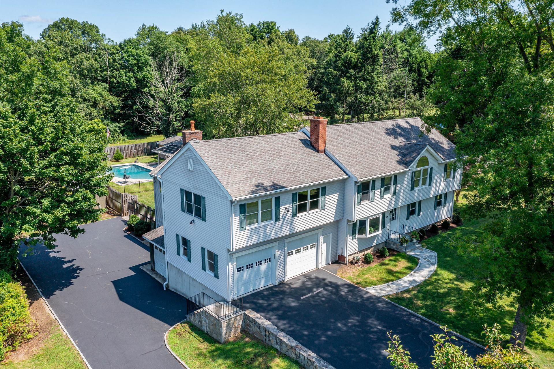 an aerial view of a house with swimming pool and garden