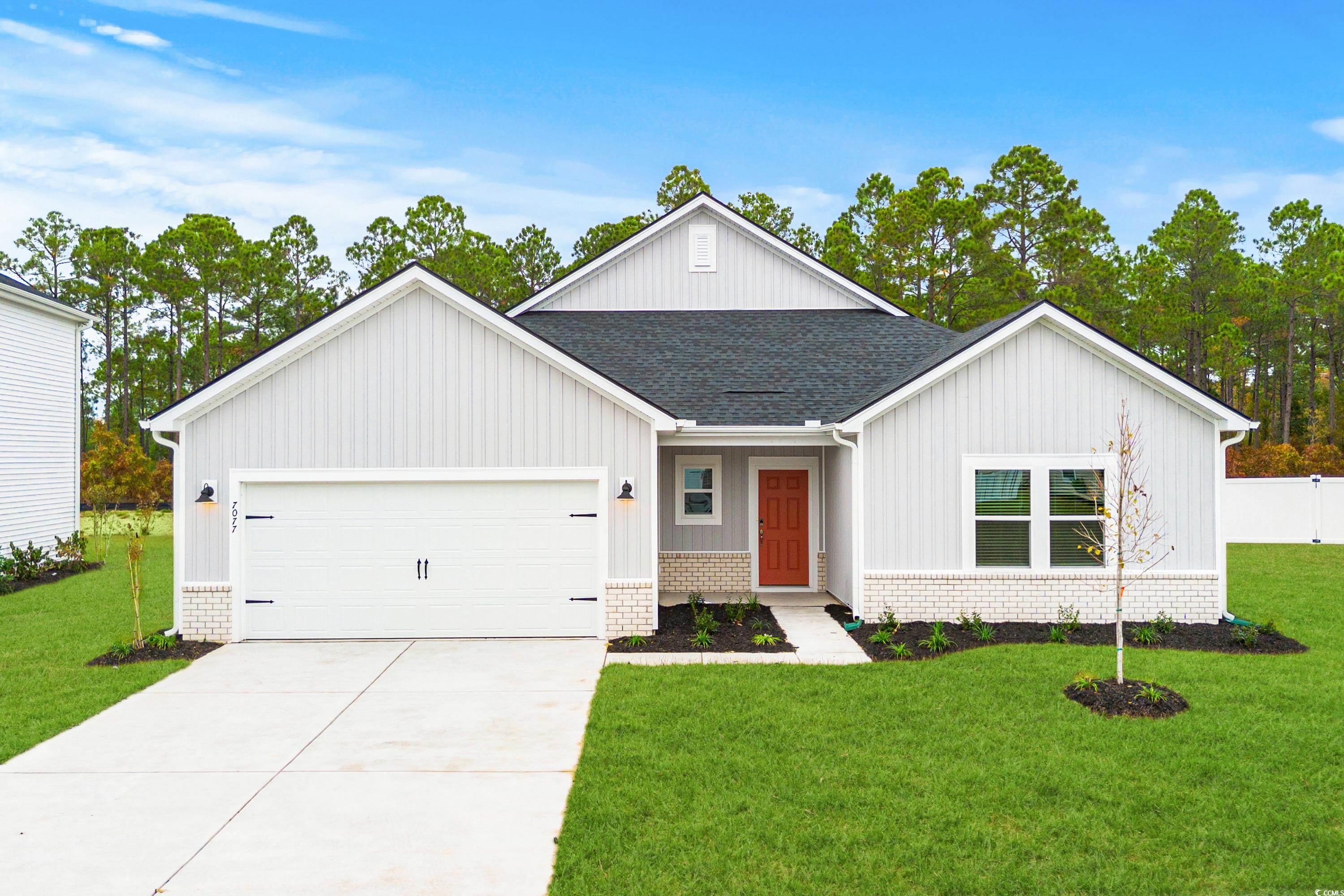 View of front of property featuring a garage and a