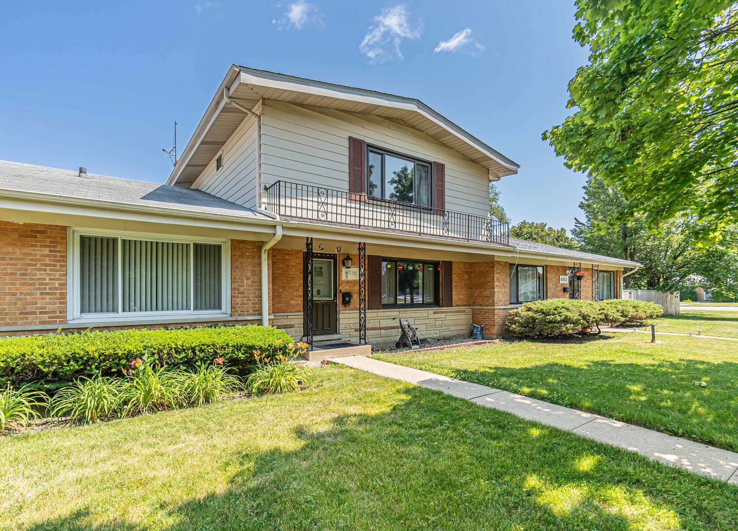 a front view of a house with a yard and porch