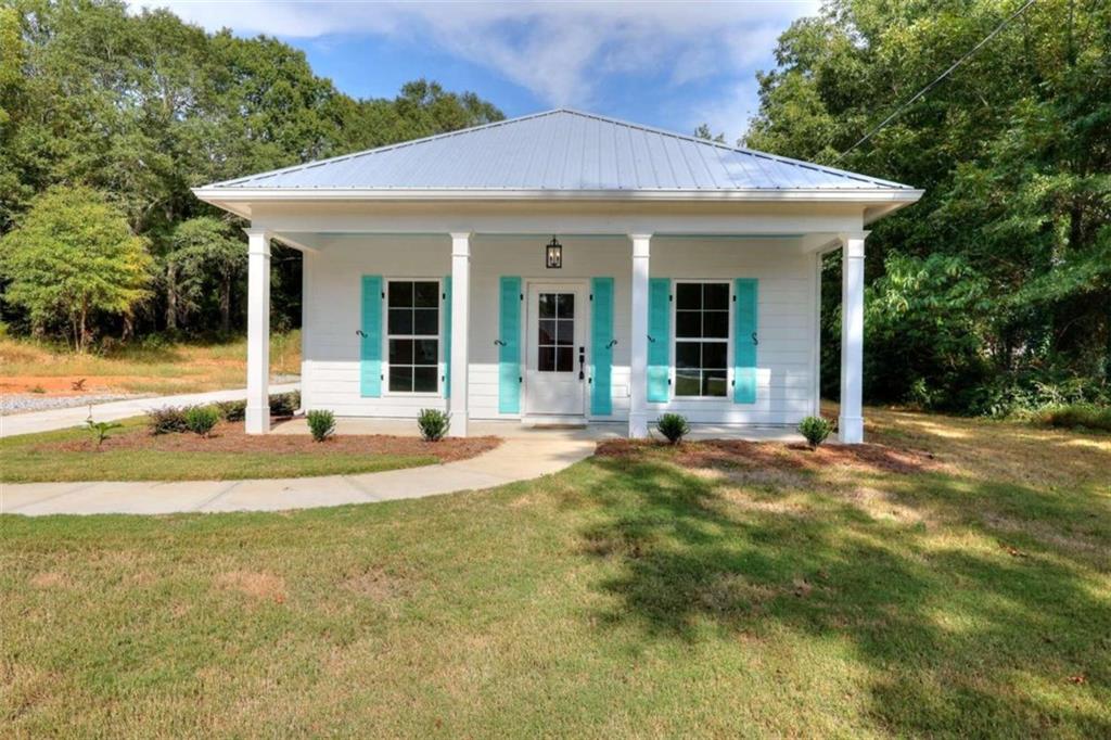 a view of a house with swimming pool and a yard