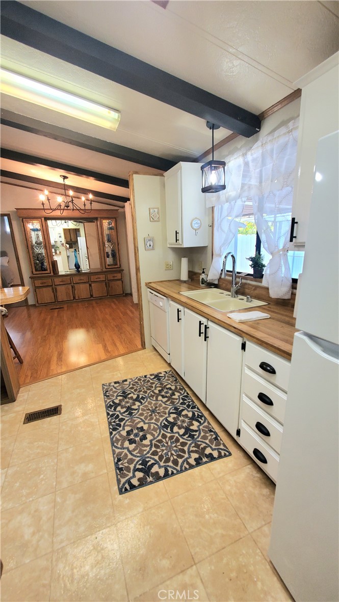 a kitchen with kitchen island sink stove and cabinets