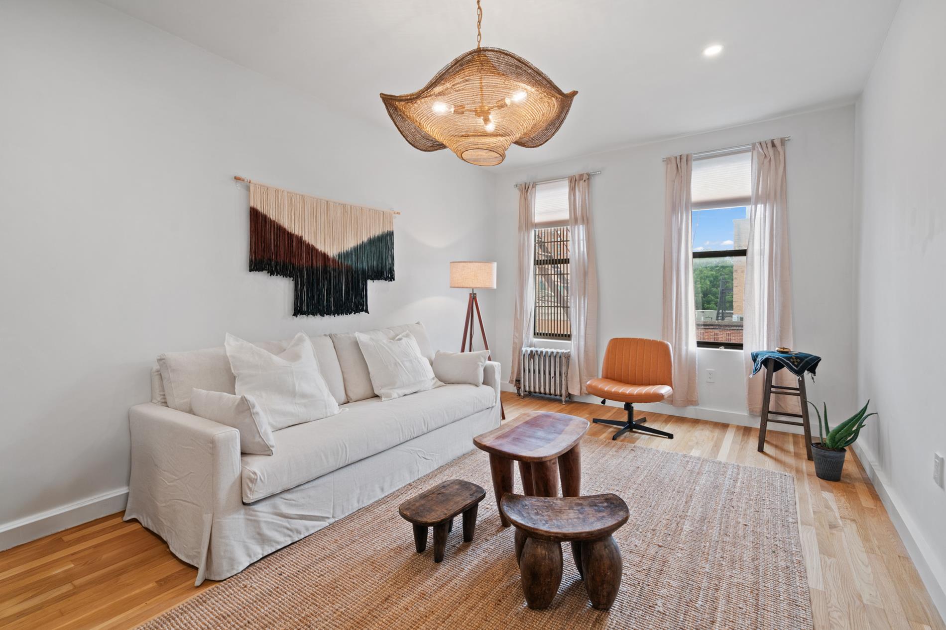 a living room with furniture a rug and a large window