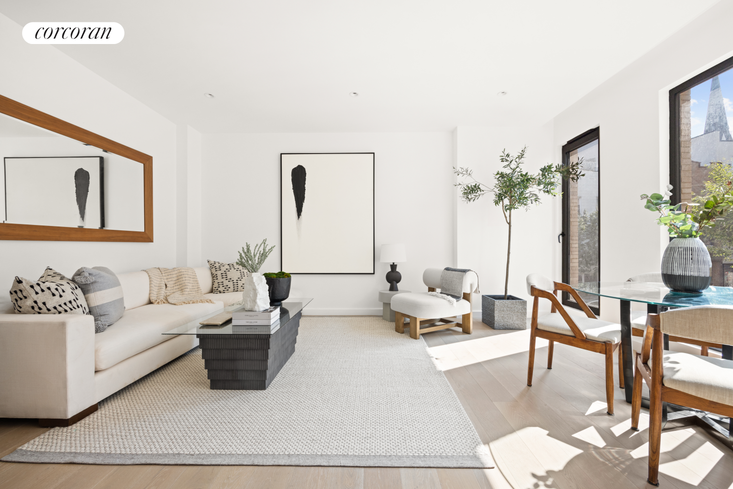 a living room with furniture and a potted plant