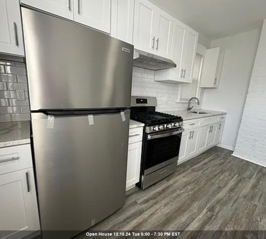 a kitchen with stainless steel appliances a refrigerator a stove a sink and cabinets