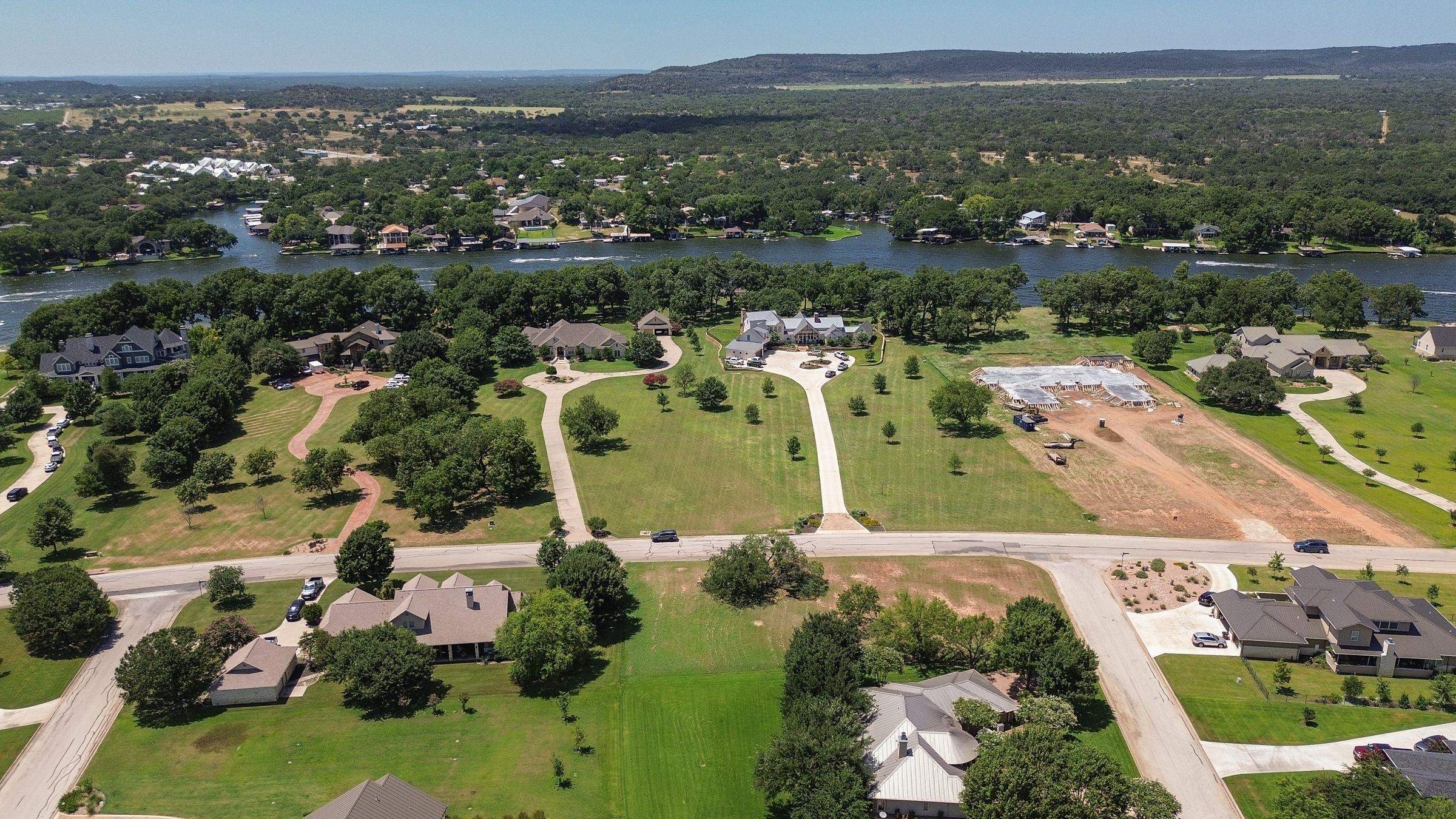 an aerial view of lake and residential houses with outdoor space