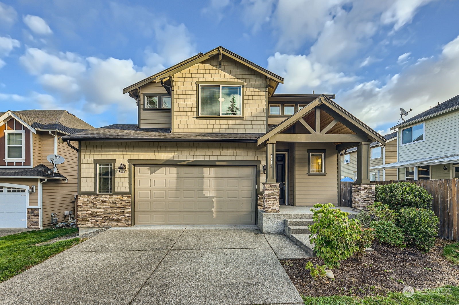 a front view of a house with a yard and garage