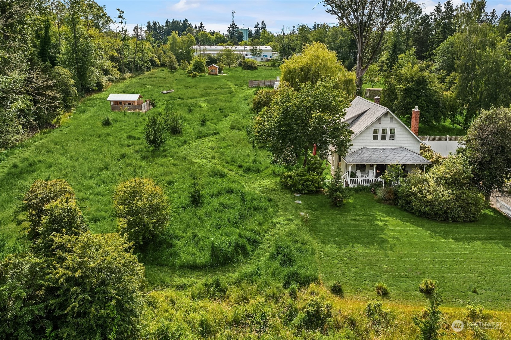 a front view of a house with a yard and trees