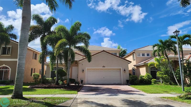 GORGEOUS 2-STORY HOME SWEET HOME!  Front North exposure, paved driveway laced w/ palm trees!