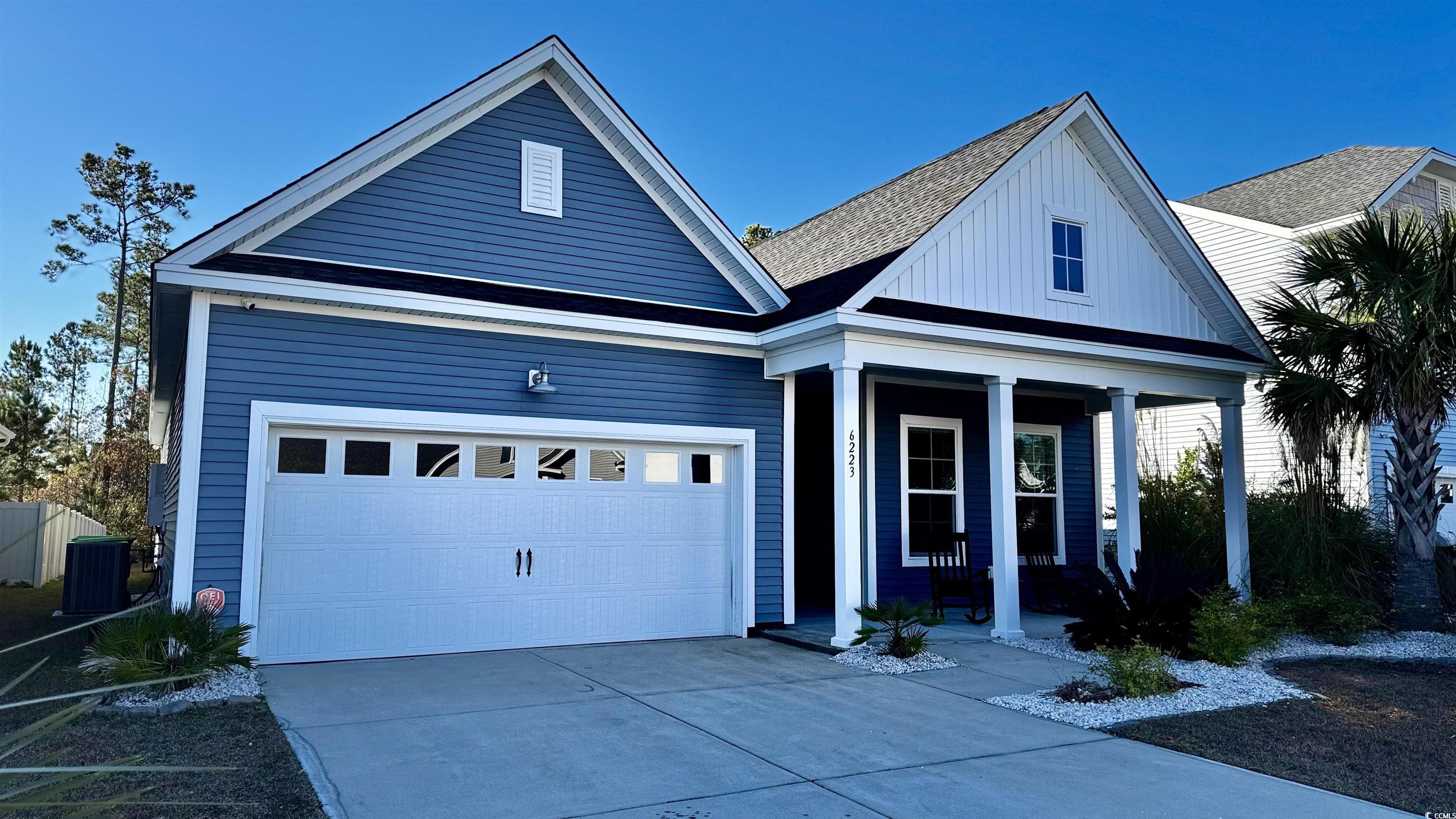 View of front of home featuring a garage, covered