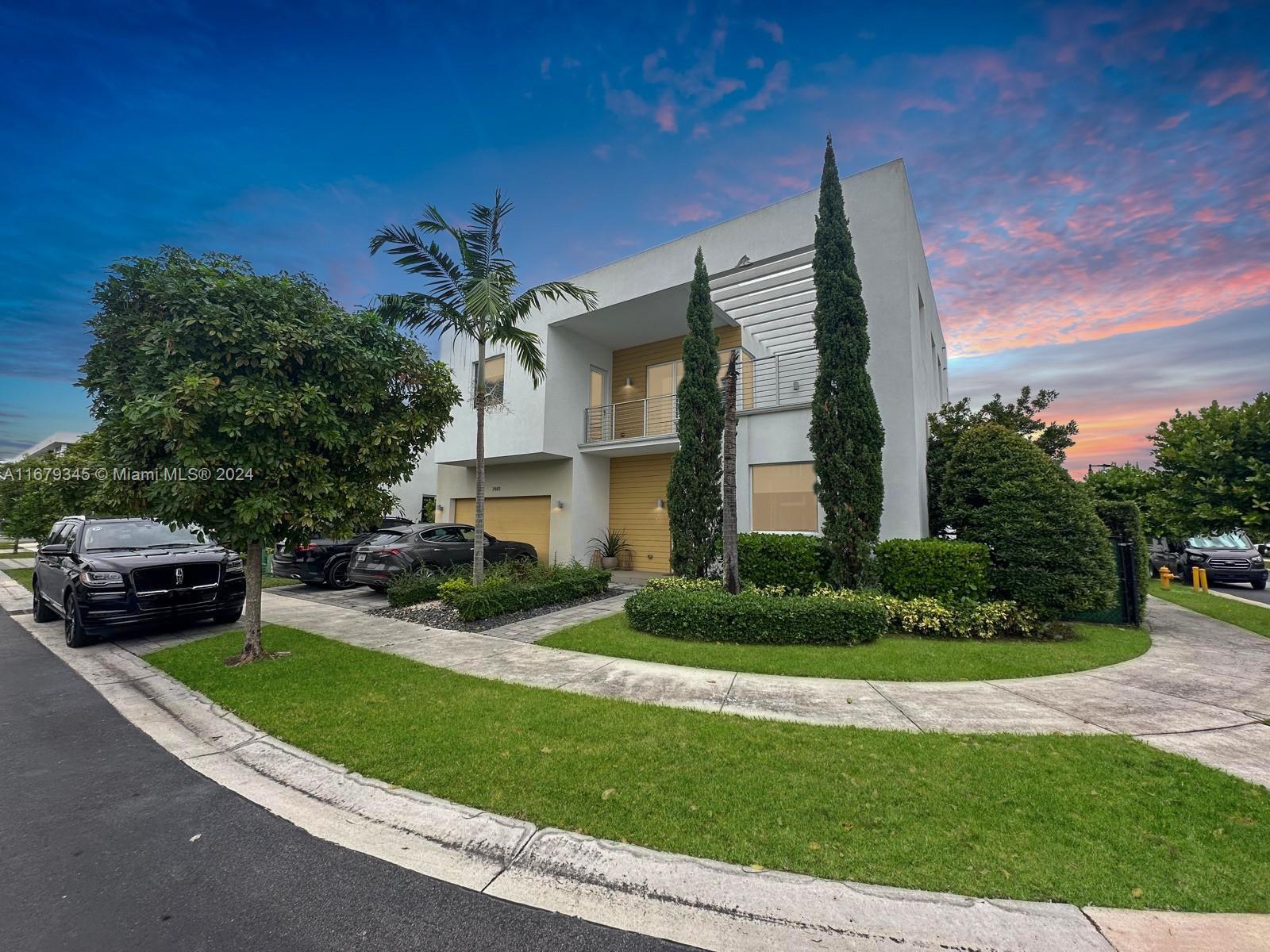 a front view of a house with a garden and yard