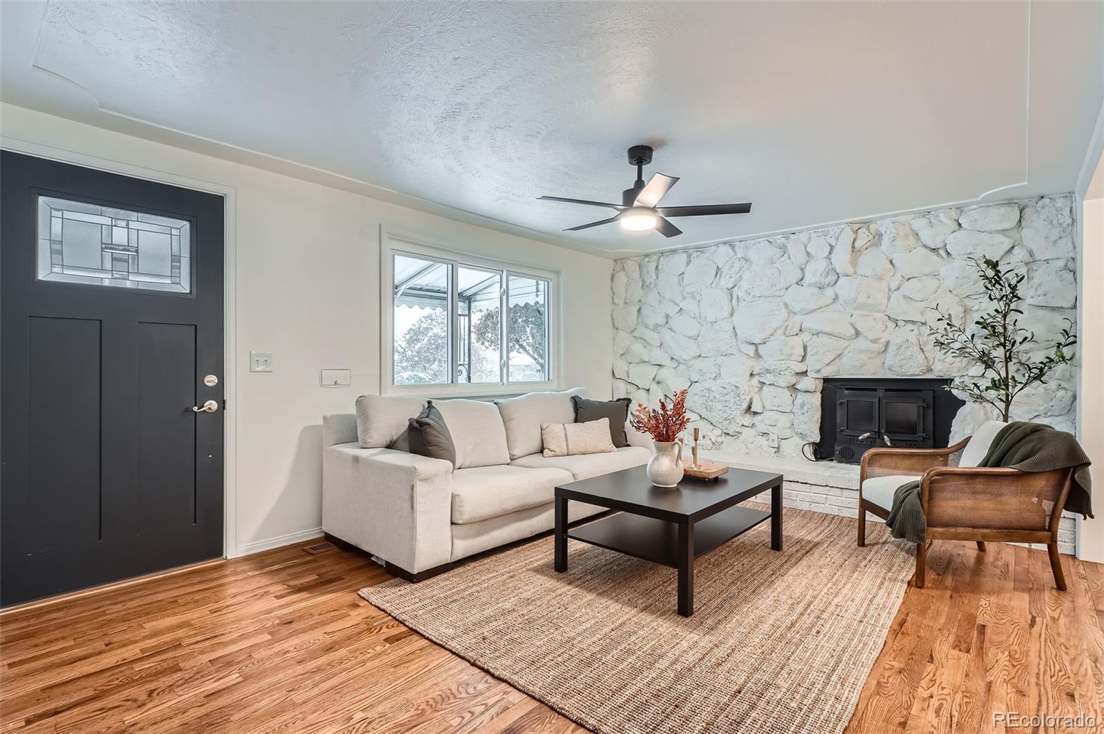 a living room with furniture and a fireplace